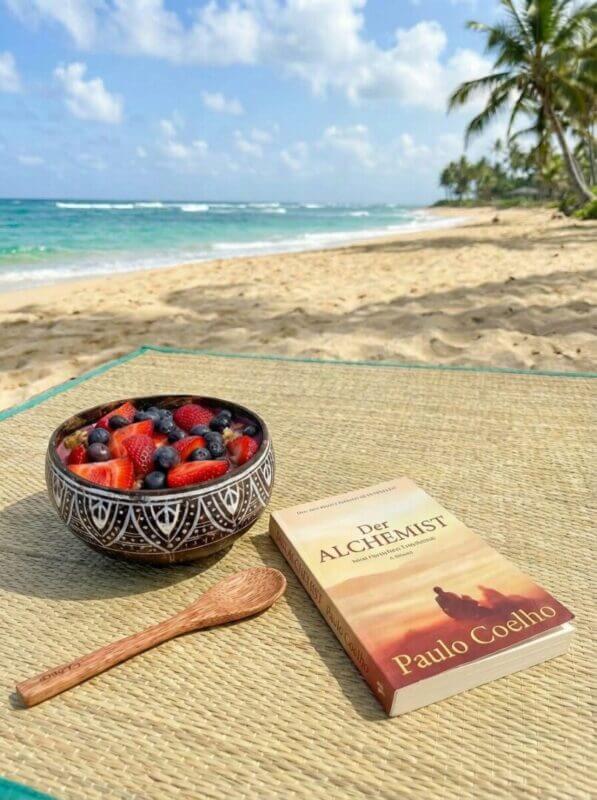 Acai Bowl Frühstück am Strand mit Buch